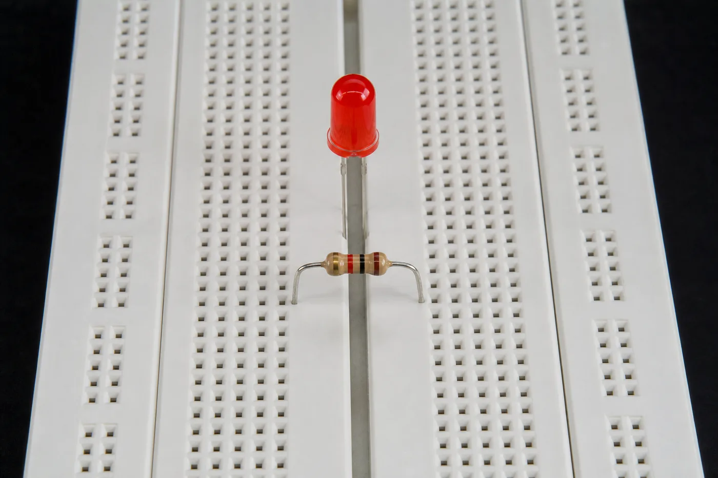 Vertical component connections on a breadboard with LED and resistor